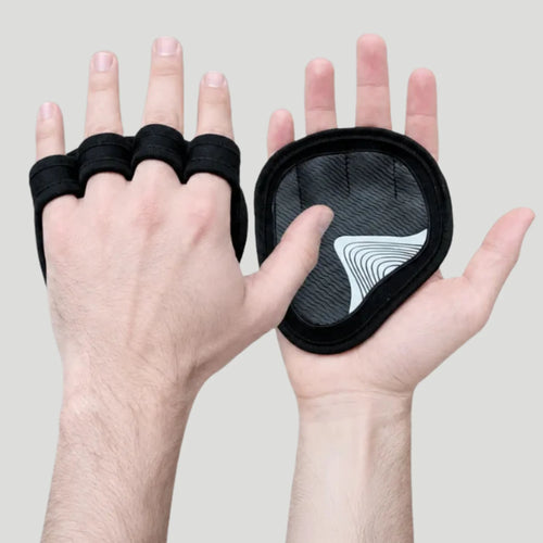 Black fingerless glove and matching wrist pad shown on two hands against a light gray background.