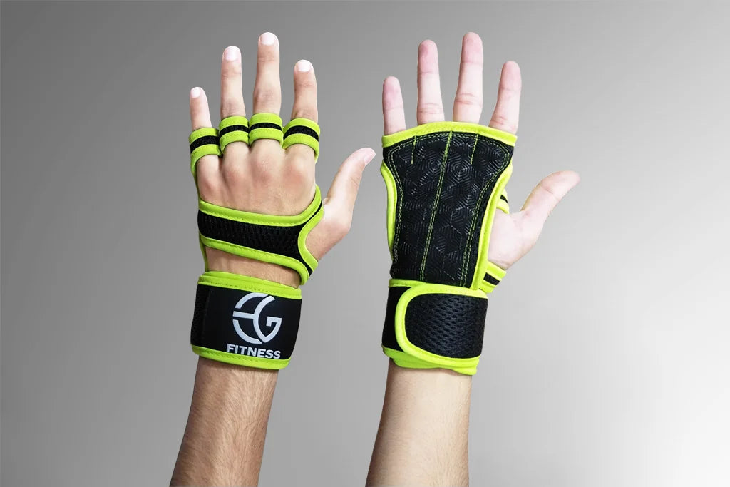 Black and green fitness gloves with wrist straps on a gray background