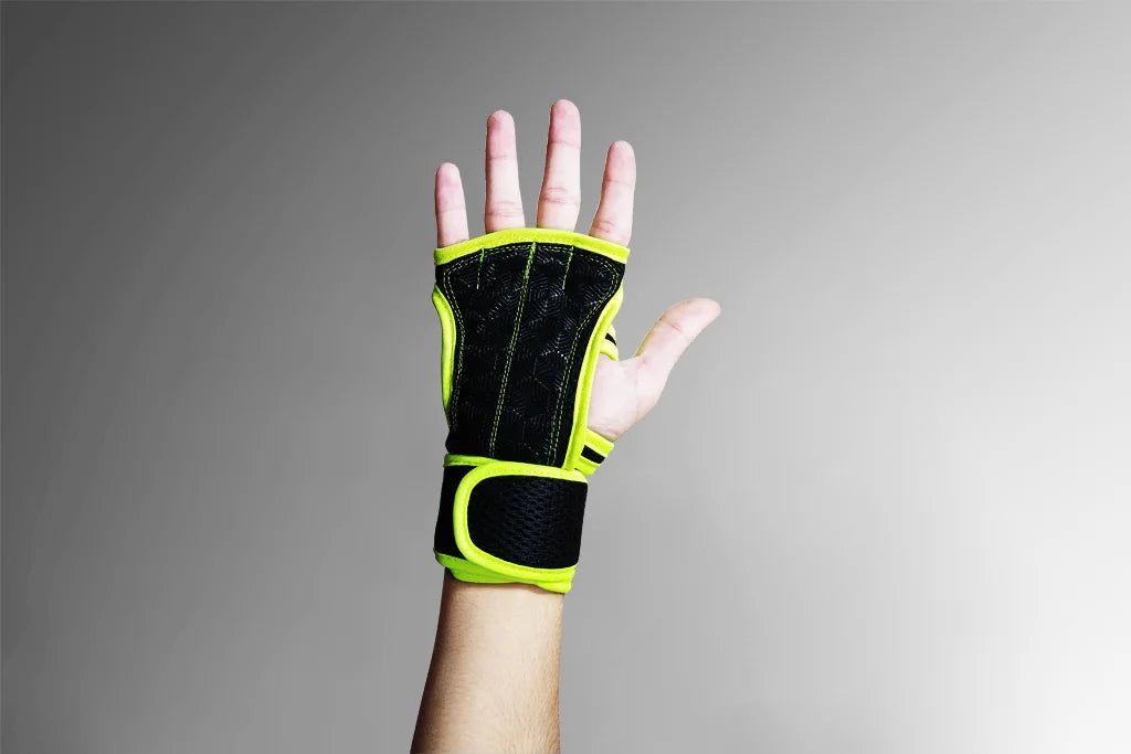 Hand wearing a black and green wrist support on a gray background