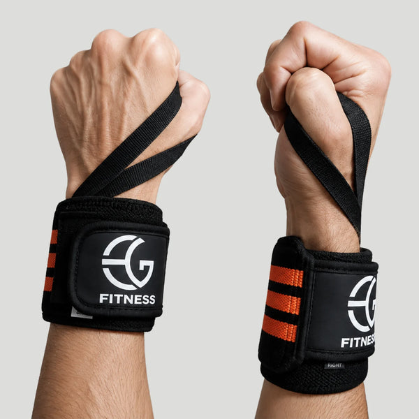 Two black wrist wraps with orange stripes and a white 'EG FITNESS' logo, worn on a person's fists against a light gray background.
